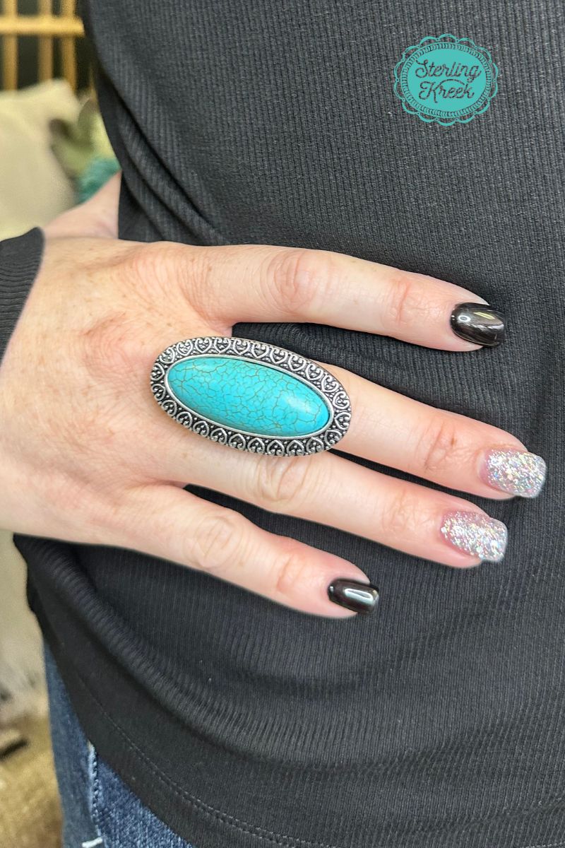 Sparkle your way to the top with our Wear It Loud Ring! This eye-catching accessory features a vibrant turquoise oval stone set in a simple silver ring, sure to make heads turn. Wear it loud and proud and show off your unique style!  Length: 1.75"