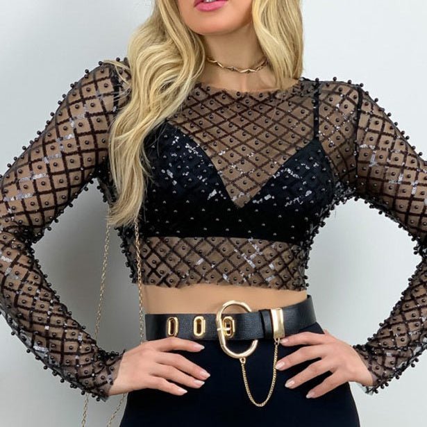 Let your look speak volumes. Dare to stand out in our After Midnight Crop Top – a unique blend of stylishness, trendiness and sexiness. Pearl accents complete this daring outfit, making you ready to take on the night. Adventure awaits!  No stretch, size up for more bust room.  95% polyester