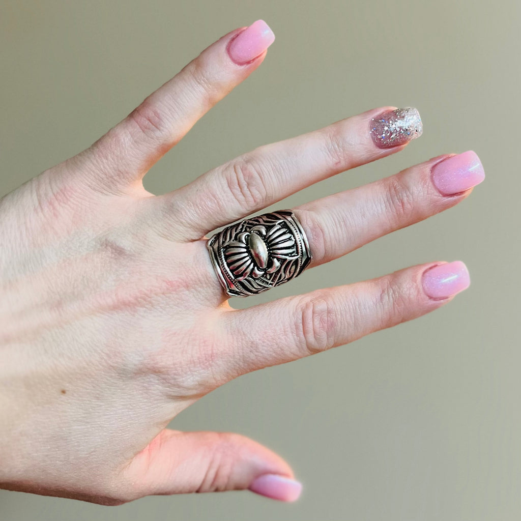 The Simply Perfect Cuff Ring is a 1"  western concho cuff ring.  The ring features a western stamped design and is very appealing on your hand.  Flexible and adjustable ring cuff.   1" in size
