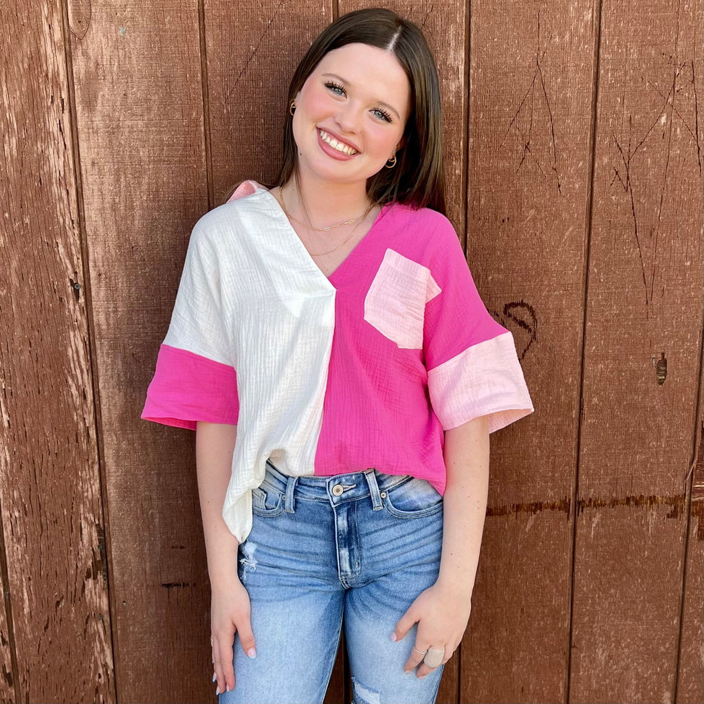 This stylish Blocked In Pink Blouse offers a modern take on the classic polo shirt. With a flattering v-neckline, crisp pink coloring, and a stylish front pocket, it's the perfect combination of comfort and sophistication. Short sleeves make it perfect for the office or a day out.  100% Cotton