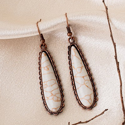 Treat your ears to a timeless look with these eye-catching Simple Tears Earrings. Crafted with an expert eye for detail, these earrings feature a stunning blend of turquoise and silver or copper and white for an eye-catching look that speaks of elegance and sophistication. With a length of 1.5”, they can be worn to the office or a night out.