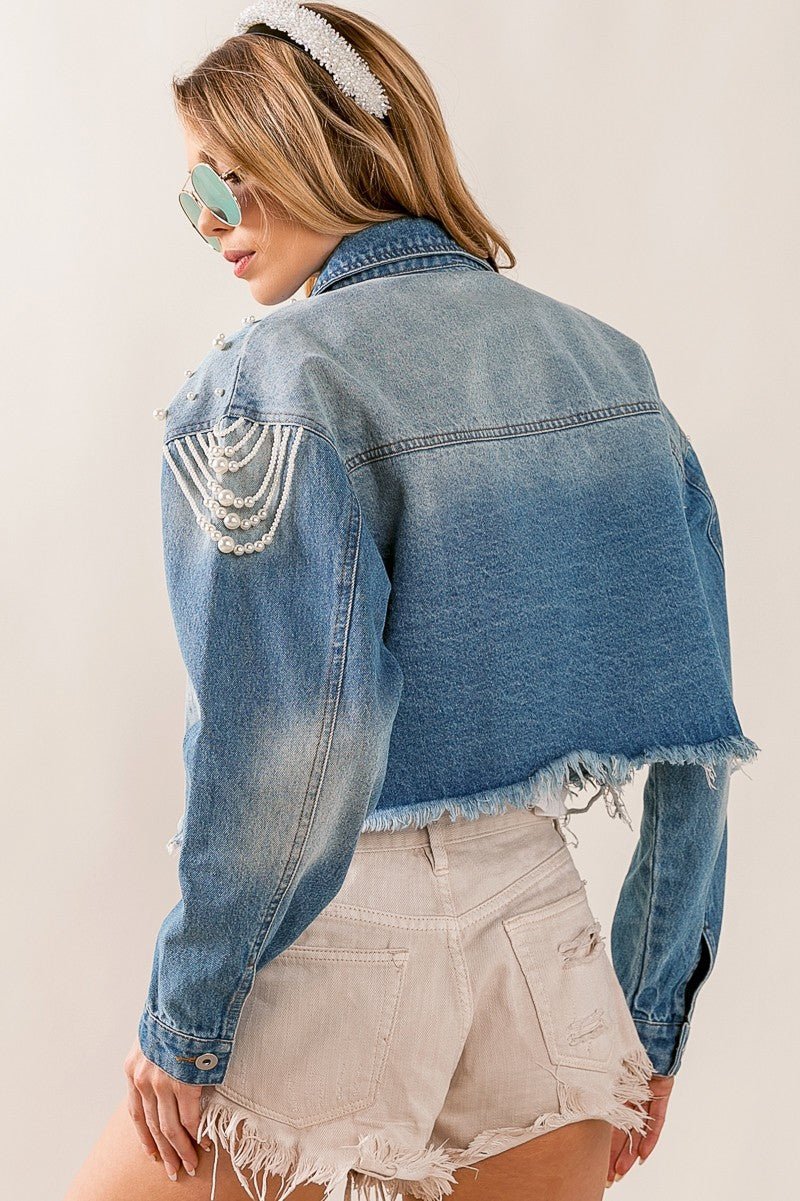 Introducing the Little Miss Priss Pearly Denim Jacket, a luxurious statement piece. Crafted from distressed denim, tastefully detailed with pearl beads, and cut in a fashionista-approved cropped silhouette, this jacket exudes modern elegance. Command attention with the Pearly Denim Jacket and be the envy of all stylish style setters.