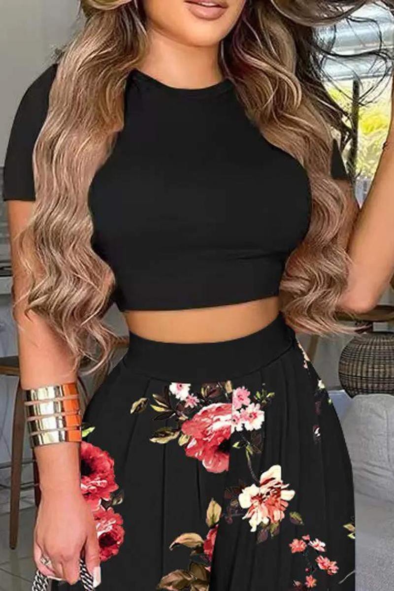 Two-piece outfit set. Comfortable outfit set. Black floral crop top outfit set. Crop top and pant set. Online boutique. Women's fashion trends. Women's western wear. Women's trendy outfit. Woman owned. Small business. 