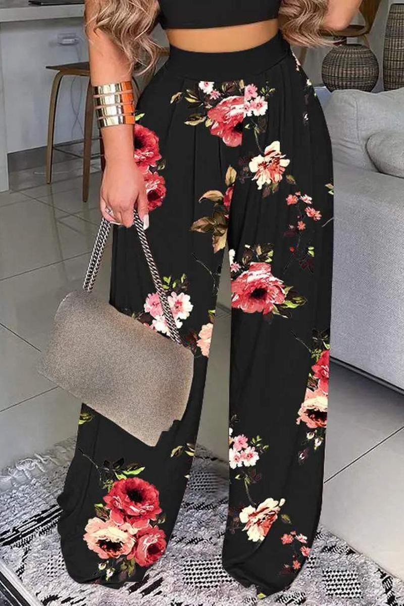 Two-piece outfit set. Comfortable outfit set. Black floral crop top outfit set. Crop top and pant set. Online boutique. Women's fashion trends. Women's western wear. Women's trendy outfit. Woman owned. Small business. 