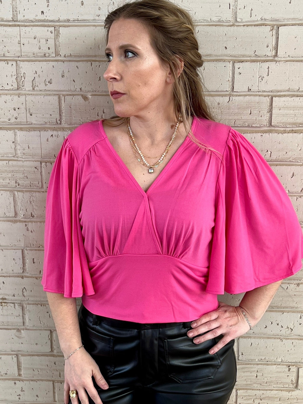Pink bell sleeve top. Cropped bell sleeve top. Fashion trends 2024. Women's outfits. Women's clothes. Women's apparel. Business top. Business clothes. Business casual. Pink top. Dressy top. Pink dressy top. Big sleeves. Spring outfit. Spring top. Boutique fashion. Women's fashion. Women's style. Small business.