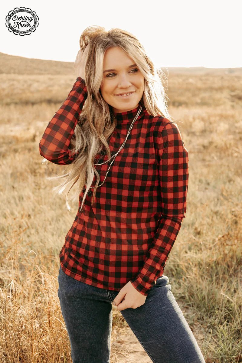 Feel on fleek and festive this winter with the Check The Halls Top! It'll keep you cozy with a stylish buffalo plaid print and long-sleeved mesh fabric. Get decked out and let everyone know who means the most this holiday season!  Model is wearing an XS and is 5'2"  96% POLYESTER 4% SPANDEX