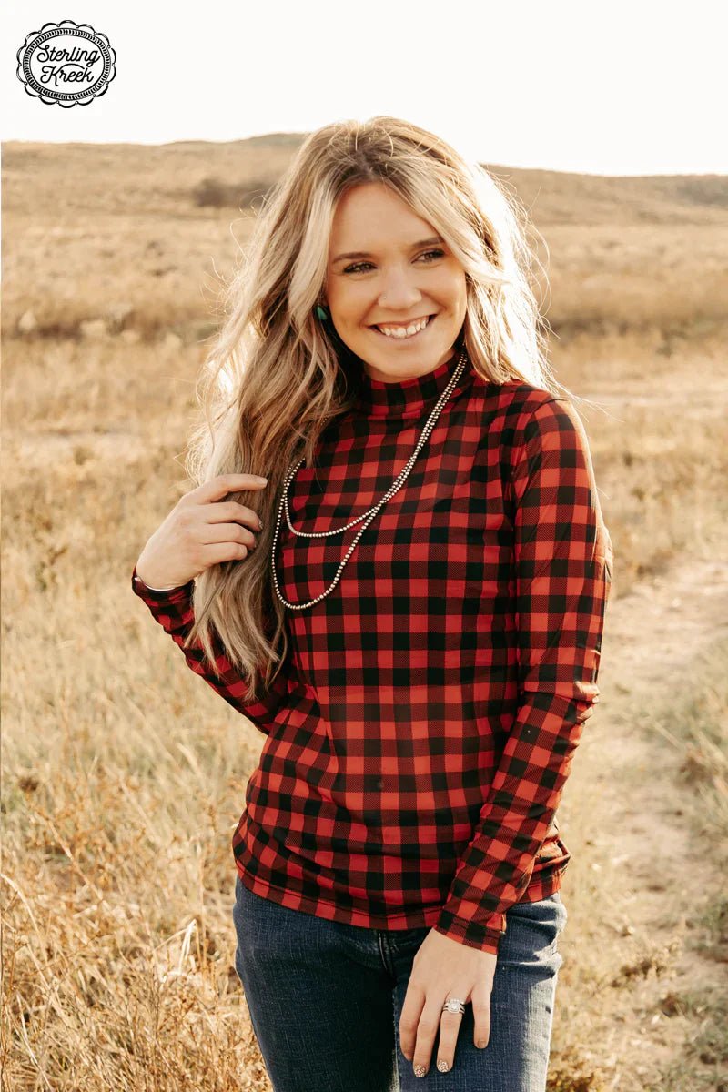 Feel on fleek and festive this winter with the Check The Halls Top! It'll keep you cozy with a stylish buffalo plaid print and long-sleeved mesh fabric. Get decked out and let everyone know who means the most this holiday season!  Model is wearing an XS and is 5'2"  96% POLYESTER 4% SPANDEX