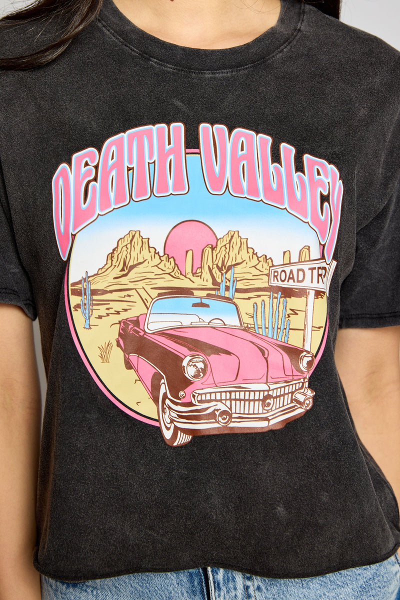 Take your wardrobe to the desert in our Death Valley Crop Top! This mineral-washed dark grey crew neck top has a raw hem and a unique desert graphic of a vintage car printed in pink. So don't just stand there, the sun's beating down - grab your Death Valley Crop Top and hit the road!