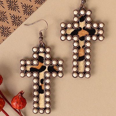 Elegant and exclusive, these Encased Cross Earrings will bring your look together with their sophisticated design. Crafted from the finest materials, they come in three color choices for you to choose from: ivory, copper and cow print, ivory, copper and leopard print, and turquoise, silver, and cowprint. With a cross design measuring 2.5" in length, these earrings will be the perfect addition to your ensemble.
