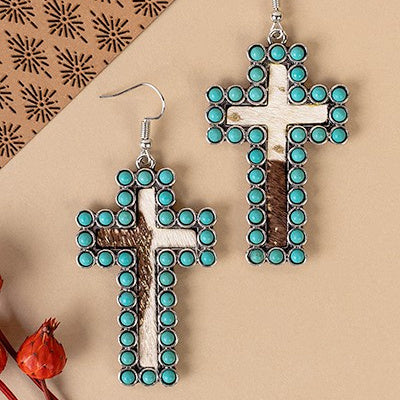 Elegant and exclusive, these Encased Cross Earrings will bring your look together with their sophisticated design. Crafted from the finest materials, they come in three color choices for you to choose from: ivory, copper and cow print, ivory, copper and leopard print, and turquoise, silver, and cowprint. With a cross design measuring 2.5" in length, these earrings will be the perfect addition to your ensemble.