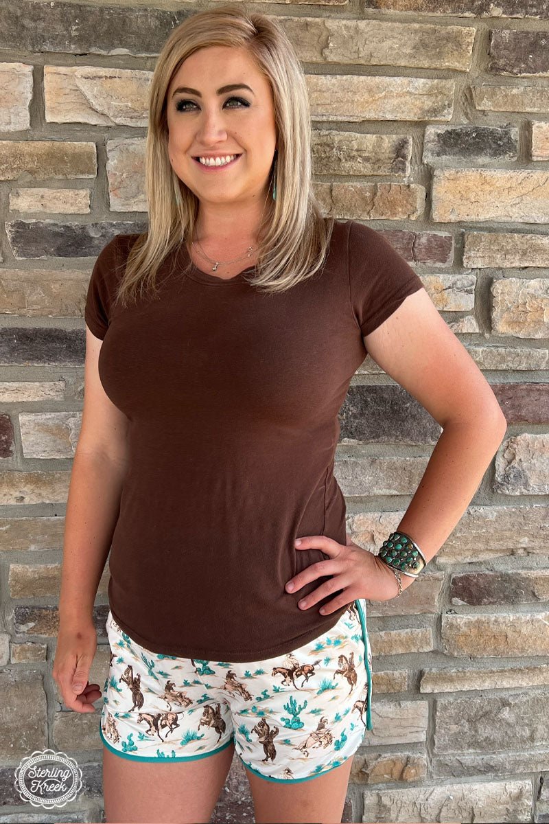 Look on point in our Round Em Up Shorts! With a turquoise outline, playful cactus and bronc print, and convenient pockets and drawstring, you'll be ready to hit the trail in style! These shorts are sure as shootin' the perfect pick for your wardrobe. Yee-haw!  80% POLYESTER  20% SPANDEX