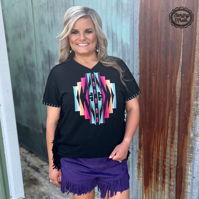 Make a stylish statement with this quirky PLUS NAVAJO NATION TOP! The black fabric, fringed sides, and beautiful embroidered Aztec design all add up to a unique look. Perfect for making a statement without taking yourself too seriously!  60% polyester 35% rayon 5% spandex