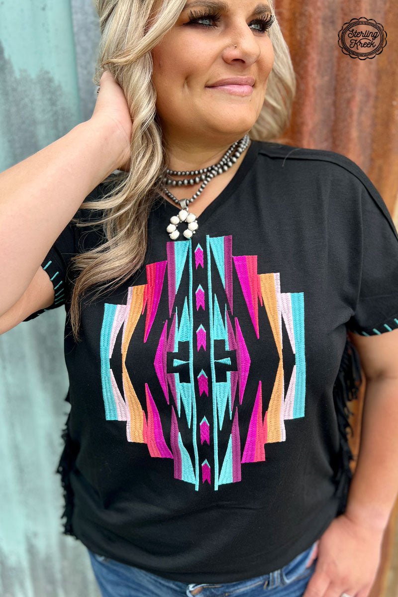 Make a stylish statement with this quirky PLUS  NAVAJO NATION TOP! The black fabric, fringed sides, and beautiful embroidered Aztec design all add up to a unique look. Perfect for making a statement without taking yourself too seriously!  60% polyester 35% rayon 5% spandex