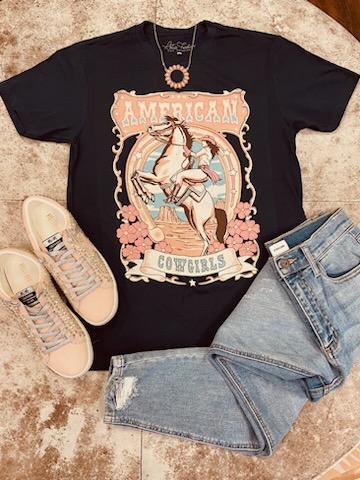 Be bold and confident in this American Cowgirls Graphic Tee! Crafted in navy 100% cotton for a comfortable and loose fit, this timeless tee finished with a classic crew neck and short sleeves is the perfect way to show off your style. Look great and feel great every day!