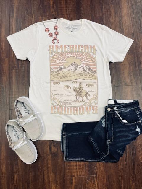 Revel in the nostalgia of the Great American West with this American Cowboys Graphic Tee. Crafted from 100% cotton for lasting comfort, it features a loose fit and classic short sleeve, crew-neck design. The ivory color offers an elegant background for the iconic Western graphic – perfect for a timeless, timeless look.