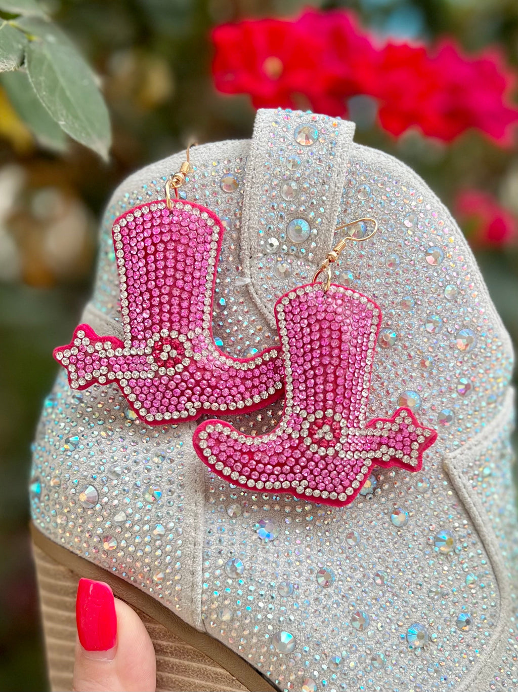 Giddy up with our Pink Puffed Up Boot Earrings! Crafted from pink Velveteen material with rhinestone inlay on the spur and spur strap, these unique accessories will spruce up any outfit. Add that final touch with the shimmering fish hook and puffed design, matched perfectly with a wink and a smile. Ride off into the sunset! 2" in length