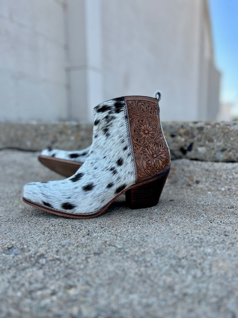 Step into luxury with the Laramie Plains Myra boots. Crafted with floral tooled leather on the ankle, the Myra offers an elegantly ornamented aesthetic. The interior zipper allows for easy on and off, while the hair on hide leather ensures quality and comfort. This ankle boot is the perfect choice for any special occasion.  2" Heel 