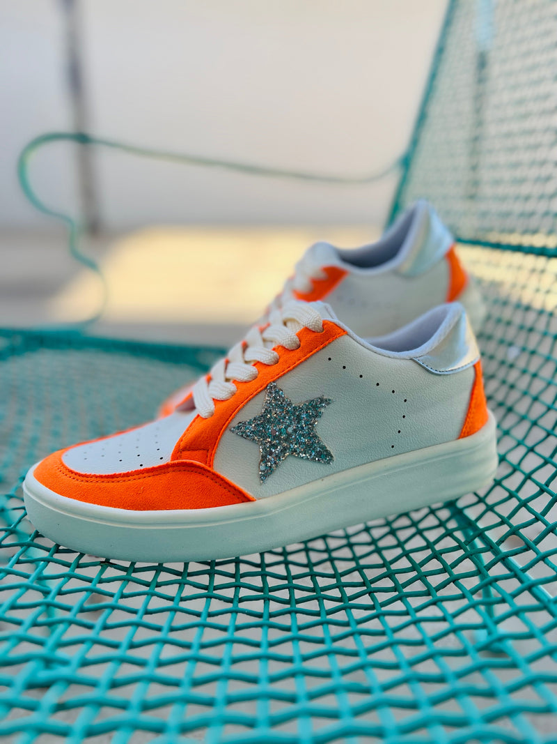 These Orange Game Day Sneakers will have you standing out from the rest! Featuring a white base sneaker with orange details, a silver star, and a sleek silver heel, these trendy shoes will keep you looking fly while giving you a comfortable and solid feel thanks to the rubber sole. Keep your style game strong!  Cushioned sole for greater comfort   Whole sizes only so size up if between sizes! 