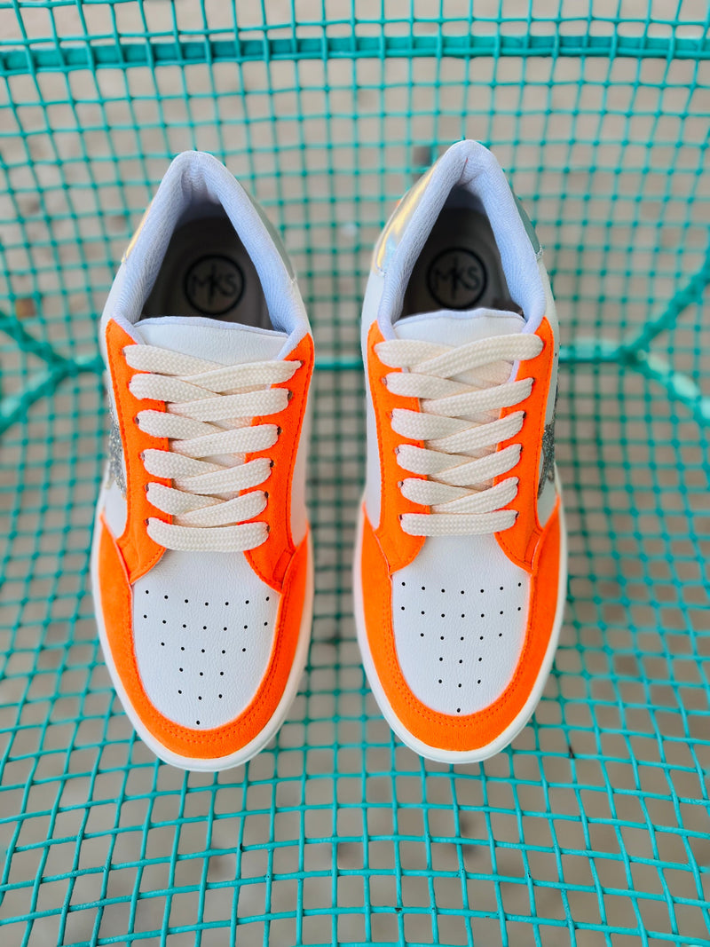 These Orange Game Day Sneakers will have you standing out from the rest! Featuring a white base sneaker with orange details, a silver star, and a sleek silver heel, these trendy shoes will keep you looking fly while giving you a comfortable and solid feel thanks to the rubber sole. Keep your style game strong!  Cushioned sole for greater comfort   Whole sizes only so size up if between sizes! 
