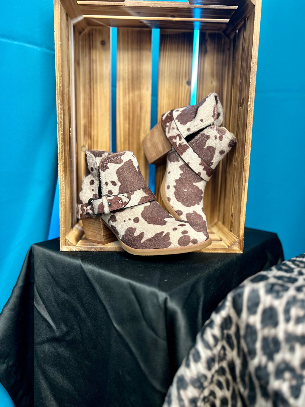 Step up your style game with the Moove Out The Pasture Booties! Featuring a bold cow print faux fur, 2 1/2" wood heel, 6" total height, plus inside and outside ankle slits and a wrap around ankle strap, these booties will take your look to the next level. Show ‘em you mean business!