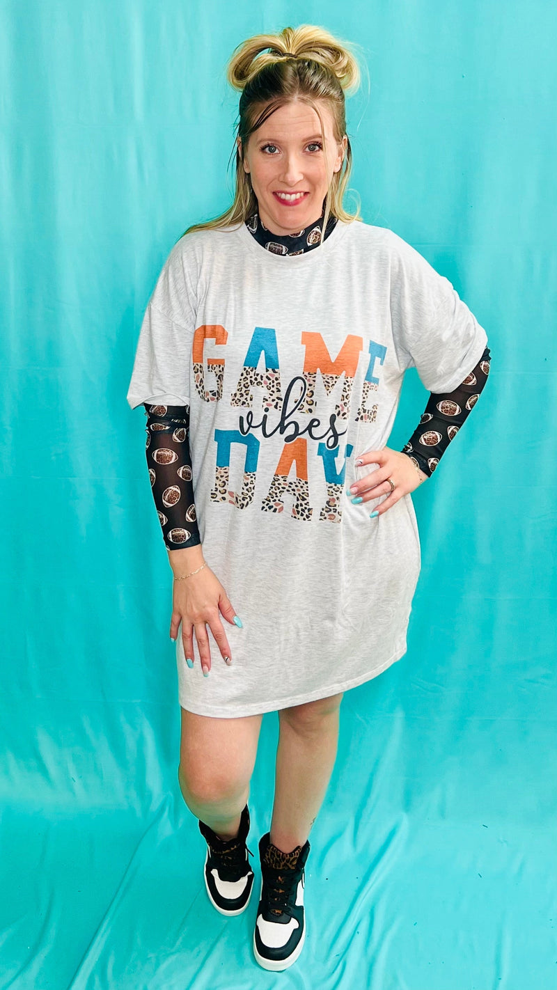 Look and feel your best on game day with this vintage-cool T-Shirt dress! The oversized grey piece features a splash of bold colors, with leopard print, turquoise, and orange accents - talk about wild fans! It’s the perfect way to show you’ve got ‘Game Day Vibes’!  78% Polyester, 18% Rayon, 4% Spandex