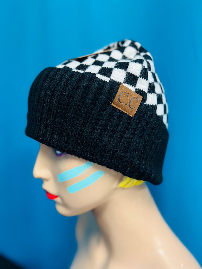 Stay stylish and warm this season with this Black and White Checkered C.C. Beanie. The intricate checkered design is truly flashy and lends an exclusive, luxurious feel. Keep cozy but make a statement with this stylish beanie.  One size fits most.   Materials: Polyester, Nylon, Wool