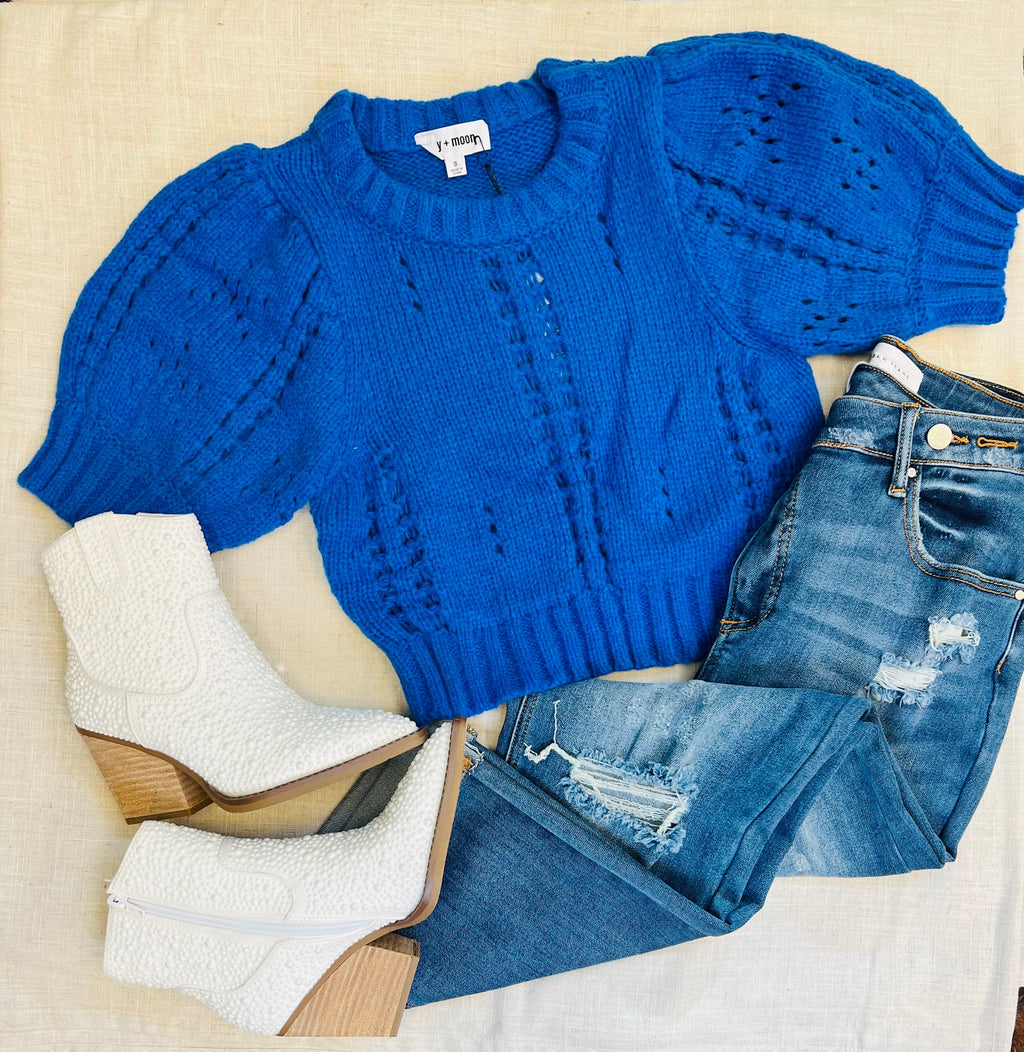 Are you looking for a way to stay cozy and cute? Then reach for our Ice Queen Cropped Sweaters! Available in both classic Blue and Ivory, these stylish pointelle sweaters show your fashion savvy, with delicate detail and comfy puff sleeves. So don't wait - make Winter wonder with the Ice Queen!