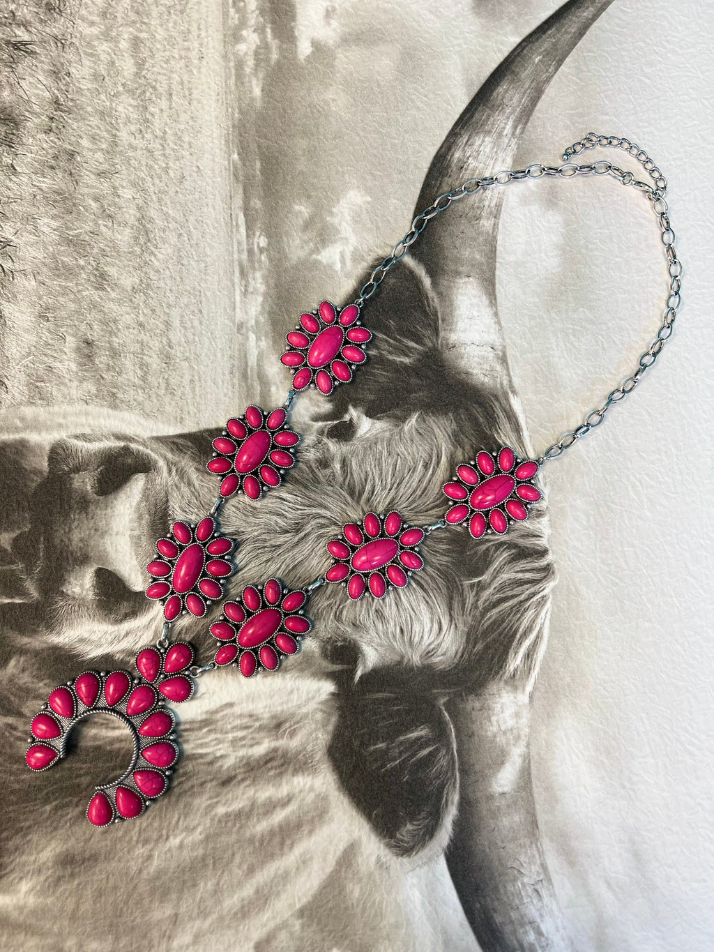 This Cowgirl Barbie Squash Necklace is sure to stand out! This stylish silver necklace features an adjustable lobster clasp, western concho style, and a playful pink stone that's sure to make a statement! So why not rope your style and lasso one today? Yeehaw!  27" chain with a 3" adjustable lobster clasp