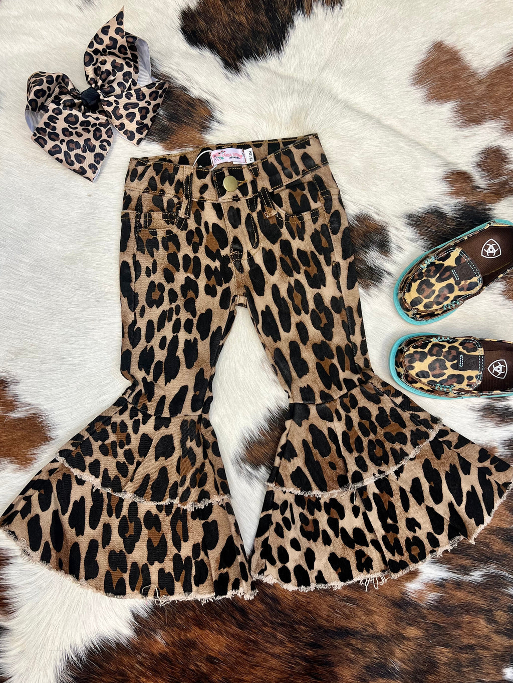 Your The Little Lainey's Leopard Bells will be rocking the trendiest jeans around with these cool bell bottoms! With a leopard print and western-style silhouette, these leopard fab bell bottoms will have them looking hip and stylish. The double tiered hem gives a unique touch, ensuring their look stands out from the crowd. Time to up their fashion game!