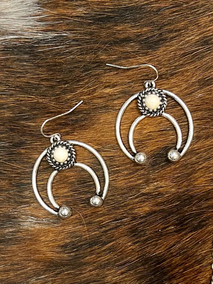 Light up the night with these Western Crescent Ivory Earrings! Perfect for a wild-west-inspired look, these 2" beauts feature a shimmering ivory stone hanging from a crescent shape. Nickel free and totally wild, they'll make sure you turn heads! Yee-haw!