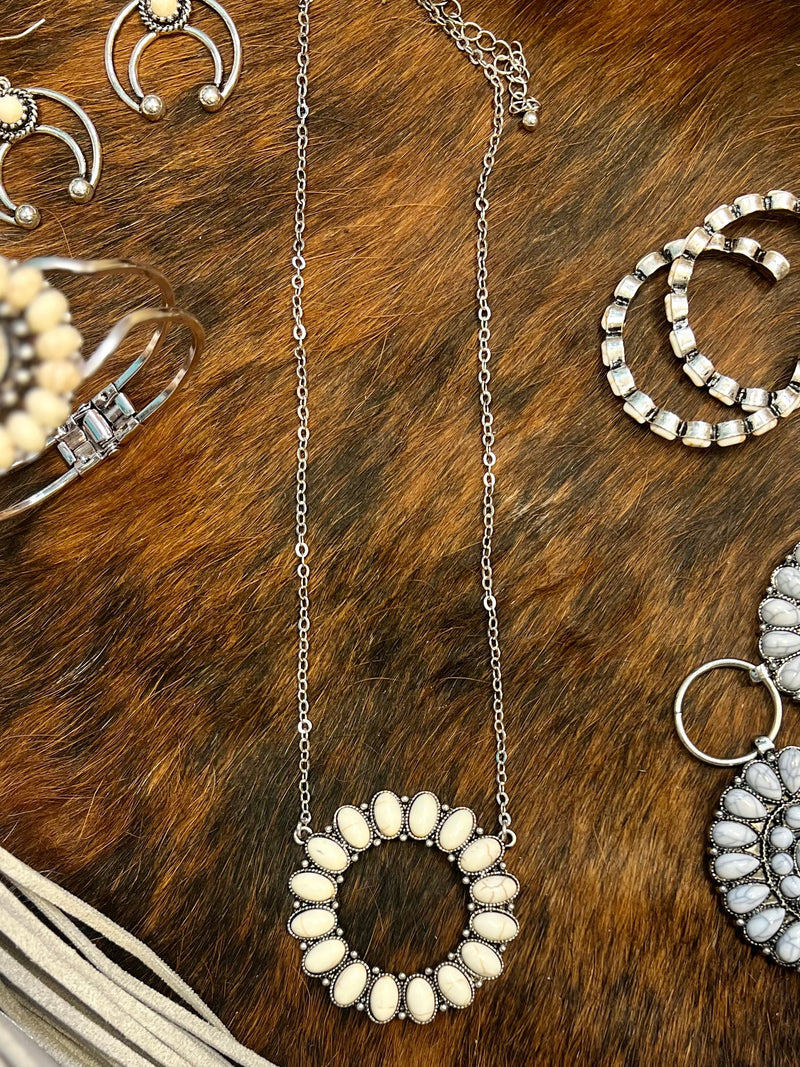 Make a statement in this western-inspired 16 Ivory Stones Necklace. Featuring a 18" silver chain with a 3" adjustable lobster clasp plus a round pendant boasting an awe-inspiring array of 16 vibrant ivory stones. So fierce and fiery, you'll be sure to raise some eyebrows. Nickle free!