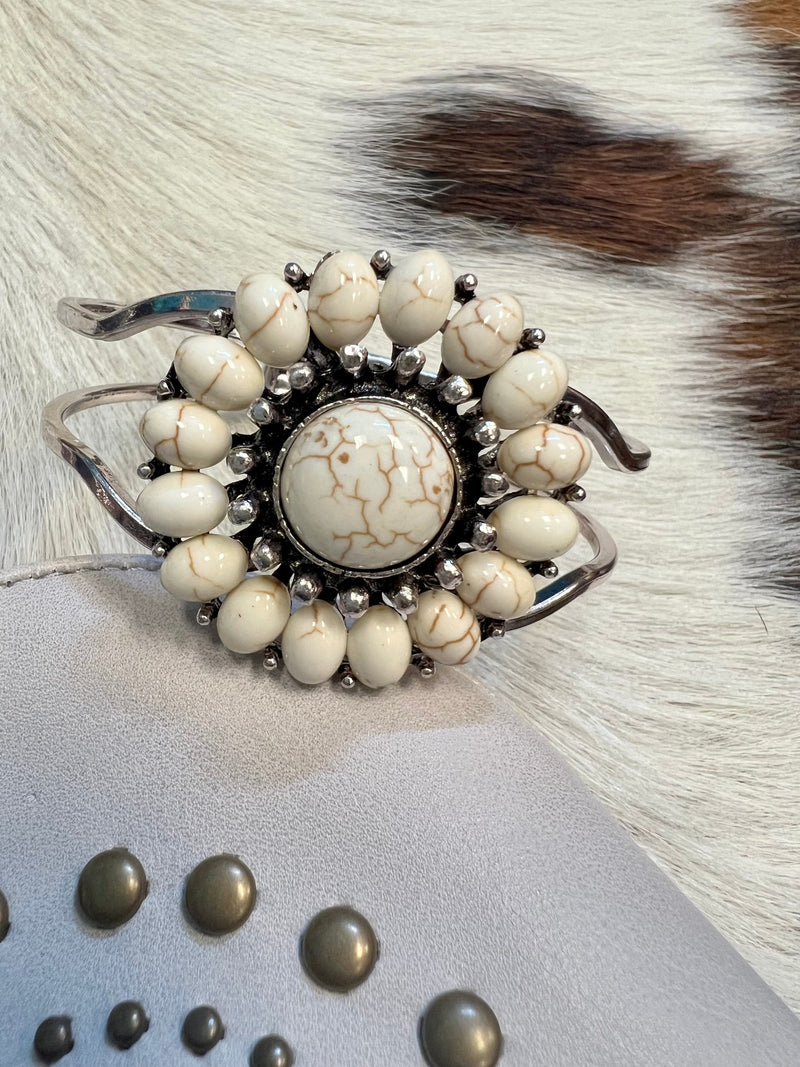 Our Ivory Bracelet will have you looking stylishly wild. With its Western-inspired design and a round stone pendant accentuated ivory stones, this cuff bracelet will add a fierce touch to your wardrobe. Not to mention, its charm size of 2", and diameter of approx 3" will fit you perfectly. Get ready to hit the town in the ultimate fashion statement—nickle free!