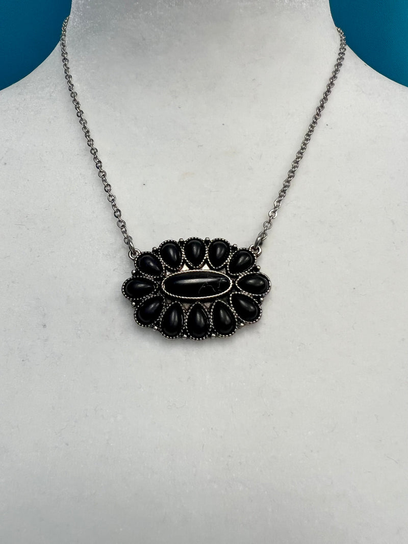 Our Black Squash Necklace will have you looking stylishly wild. With its Western-inspired design and a round stone pendant accentuated with black stones, this silver necklace will add a fierce touch to your wardrobe. Not to mention, its charm size of 2", 18"chain with 3" extender will fit you perfectly. Get ready to hit the town in the ultimate fashion statement—nickle free!