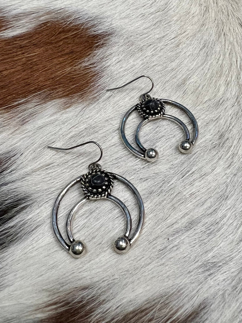 Light up the night with these Western Crescent Black Earrings! Perfect for a wild-west-inspired look, these 2" beauts feature a shimmering black stone hanging from a crescent shape. Nickel free and totally wild, they'll make sure you turn heads! Yee-haw!