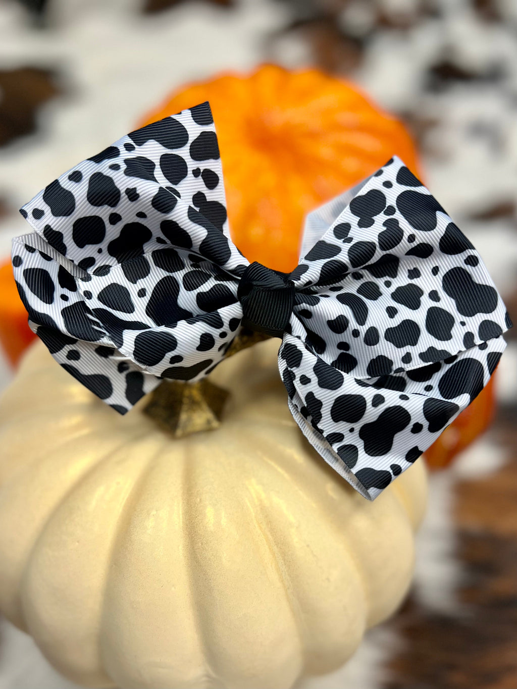 Look moooo-dorable in this Cow Print Bow! The black & white cow print of this 6" bow is sure to make a statement - without having to mooooo-ve an inch! Attached to an alligator clip for easy styling, you'll be ready to face every day with a bit of sass.
