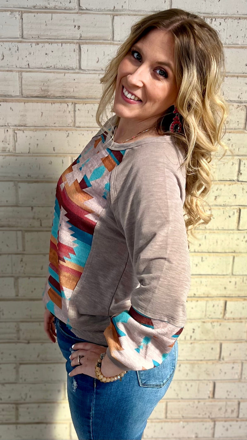 This Casually Southwestern Top will take you from the city to the desert in mocha-hued style! With a long sleeve design, terry cloth comfort, and Aztec print, you'll be ready to rock 'n' roll with a mire cut edge detailed scoop neckline. It's sure to be the perfect pick for your next southwestern adventure!   63% Polyester, 34% Rayon, 3% Spandex