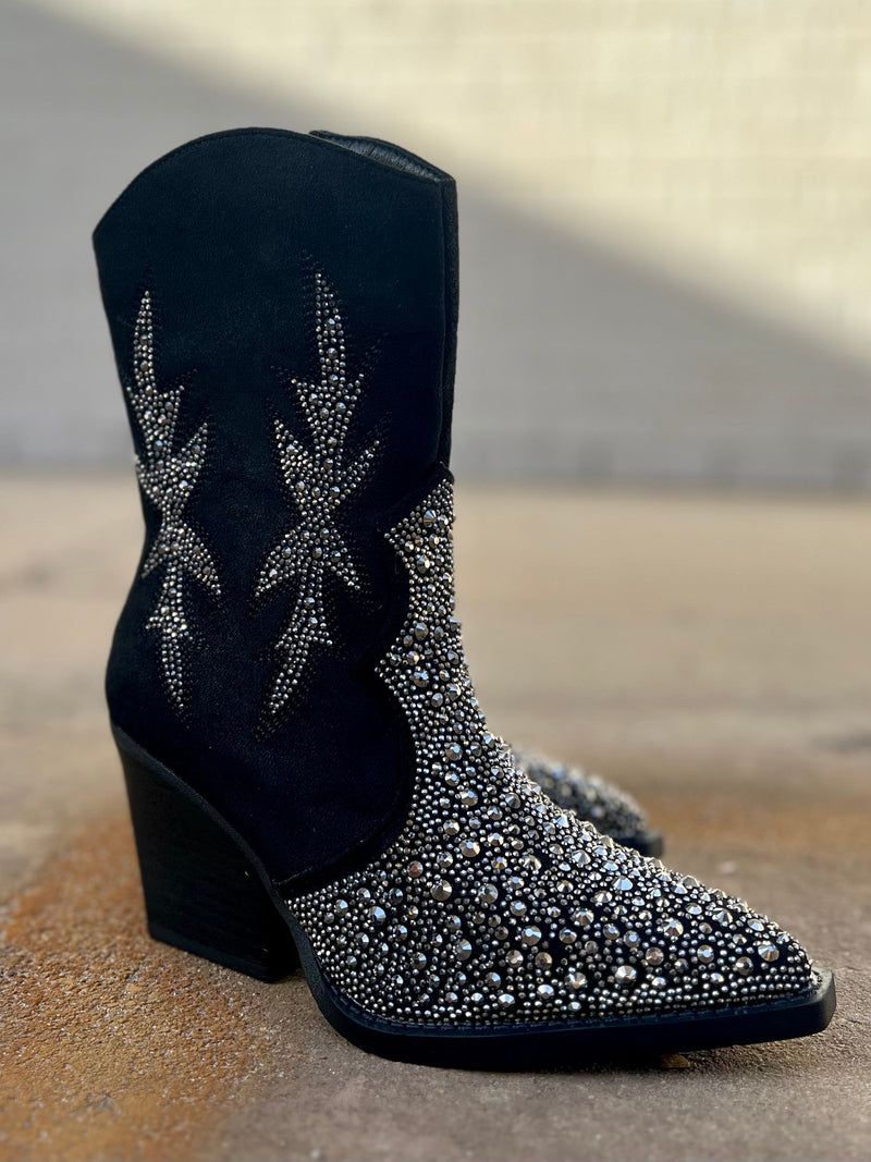 Add Glamour to any party with these "Lux" Black Rhinestone Booties with front rhinestone detailing and side flared out feathered detailing. These booties have a Pointed Toe Silhouette,  side zipper closure, 3" wooden block heel, 7" calf length from ankle to top of bootie. 10" total inches tall from sole to top of Bootie.  These booties are made of a soft suede like material. 