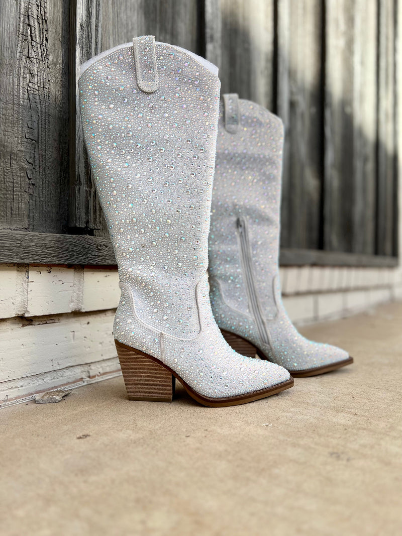 Add Glamour to any party with these Tall In a Silver Cadiallac Boots with all over iridescent rhinestone detailing. These boots have a Pointed Toe Silhouette,  side  inside ankle zipper closure, 3" wooden block heel, 15" knee length from ankle to top of boot.  18" total inches tall from sole to top of Bootie.  