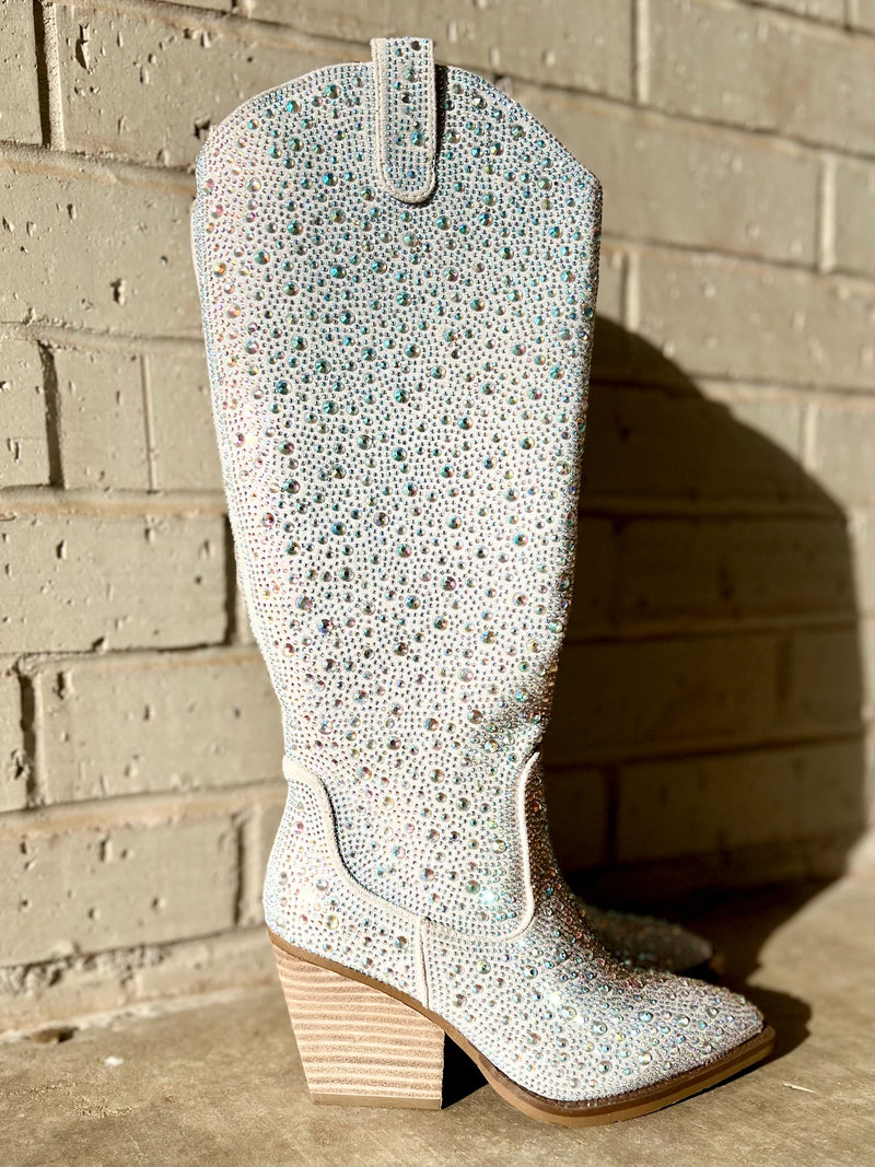 Add Glamour to any party with these Tall In a Silver Cadiallac Boots with all over iridescent rhinestone detailing. These boots have a Pointed Toe Silhouette,  side  inside ankle zipper closure, 3" wooden block heel, 15" knee length from ankle to top of boot.  18" total inches tall from sole to top of Bootie.  