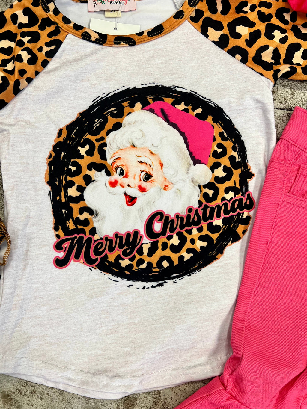 Be the talk of the town with this unique KIDS Wild Santa Top! Featuring a white raglan base, fun leopard sleeves, and a Santa Claus graphic, this tee is sure to be a hit. With the words "Merry Christmas" and a ruffled sleeve, you'll be festive and funny! ! Ho-Ho-Holy Raglan Time! 95% Cotton 5% Spandex