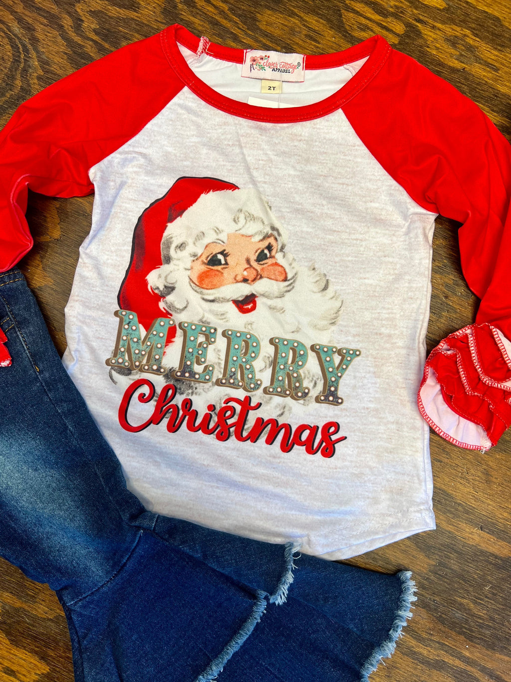 Be the talk of the town with this unique KIDS Vintage and Merry Top! Featuring a white raglan base, fun red ruffled sleeves, and a Santa Claus graphic, this tee is sure to be a hit. With the words "Merry Christmas" and a vintage Santa Claus, you'll be festive and funny! ! Ho-Ho-Holy Raglan Time! 95% Cotton 5% Spandex