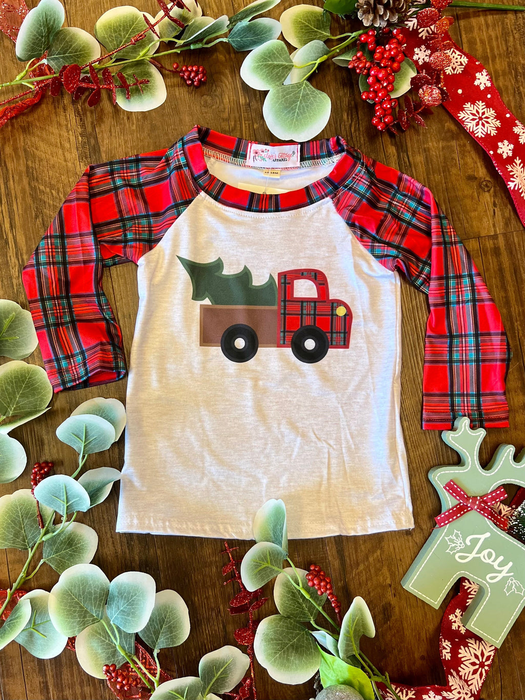 This KIDS Plaid Vintage Truck Raglan is perfect for creating fun, festive holiday memories! Featuring an adorable vintage truck with a Christmas tree, this ultra-soft raglan in white, with red plaid trim and red plain sleeves, is sure to bring the cheer. Yeehaw! 95% Cotton 5% Spandex.