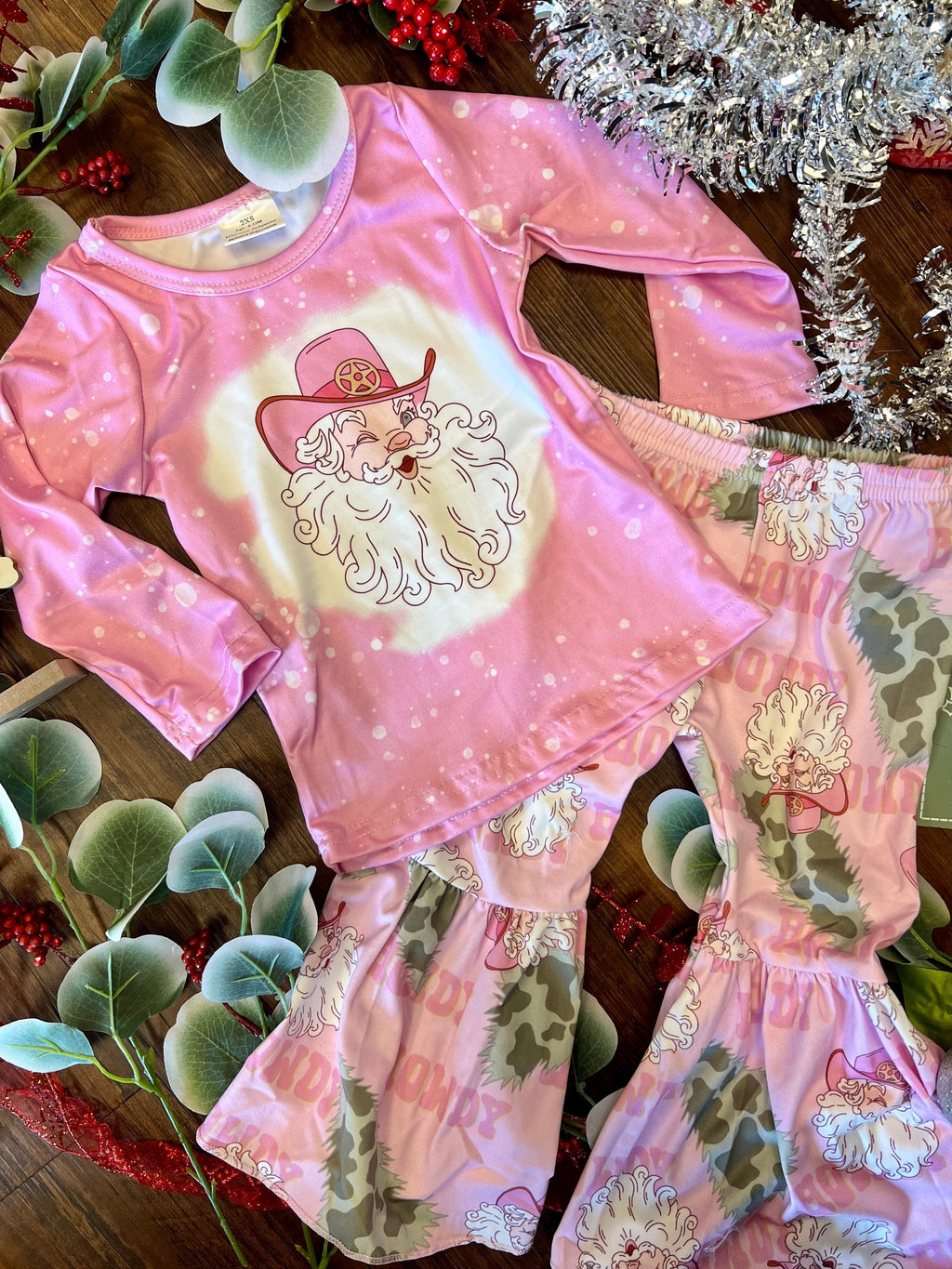 This festive Howdy Pink Santa Two Piece Set is irresistible! The butter soft cotton blend with playful Vintage Santa Claus, Christmas trees, and flared Bells will look oh-so-cute on your little one. Spread some Christmas cheer and make this holiday season one for the books!! 95% Cotton 5% Spandex. Ho Ho Ho!