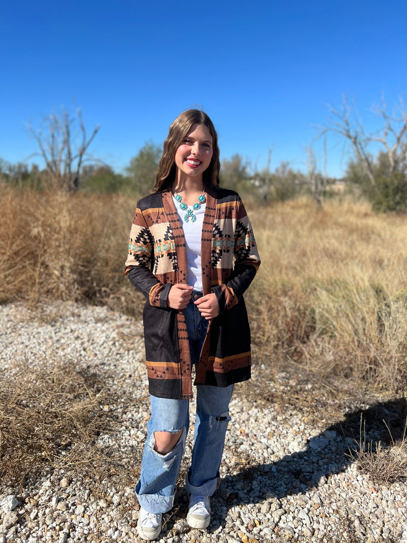 If you're ready to threw on some sty-lay, throw on this Mountain Porch Sittin' Cardigan! Keep cozy with its long sleeves and pull together your aztec style with the brown, black, and cream hues. You'll be cozy yet adventurous all at once. Word!