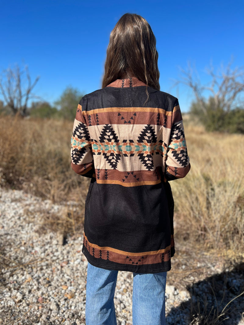 If you're ready to threw on some sty-lay, throw on this Mountain Porch Sittin' Cardigan! Keep cozy with its long sleeves and pull together your aztec style with the brown, black, and cream hues. You'll be cozy yet adventurous all at once. Word!