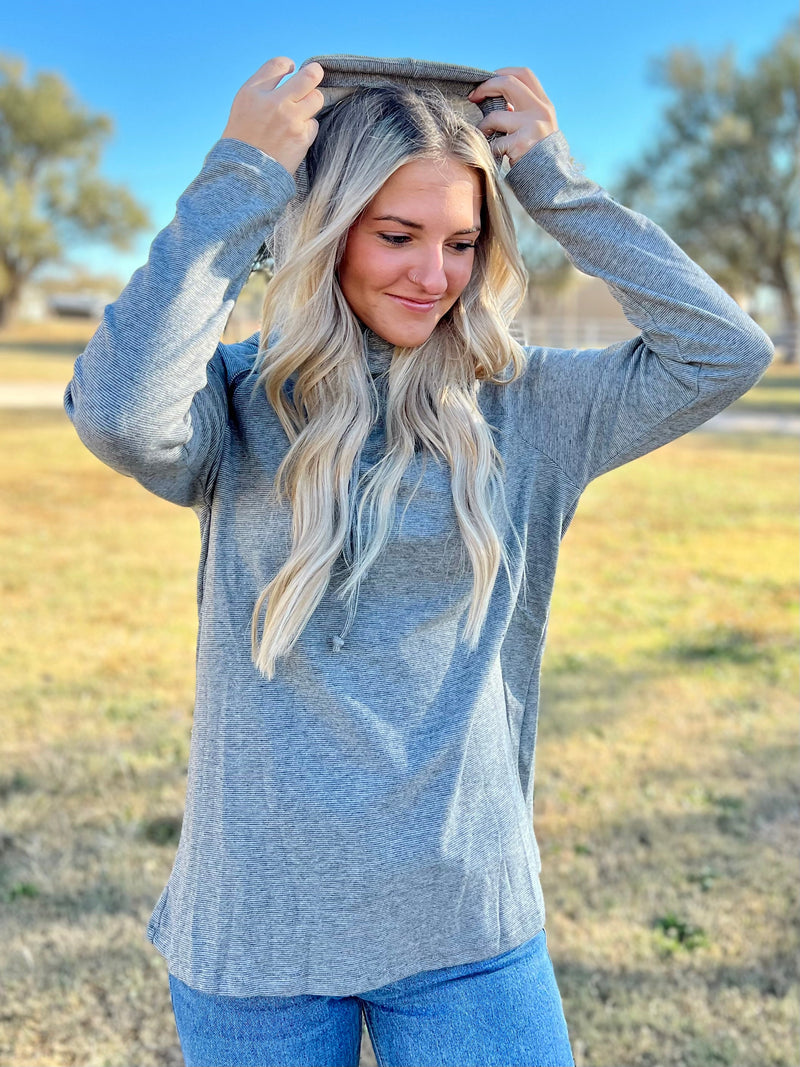 Take your style to new heights with this On Cloud 9 Pullover! It's grey striped, hooded and raglan, and features a unique zipper detail for a modern look. Knit from a cozy blend of Polyester, Rayon and Spandex, you'll stay comfy and look cool in this long sleeve top. Soar to the top of the fashion world!