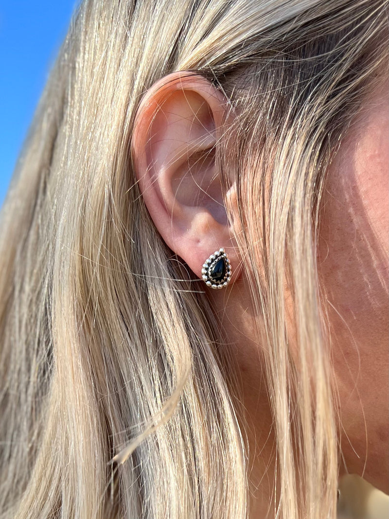 These sophisticated Black Onyx Stud Earrings are crafted from genuine sterling silver featuring an intricate tear drop shaped black onyx stones. These studs measure 1/4" in size and have a classic post back closure. The perfect accessory for an elegant look.  Suggested Retail:$75