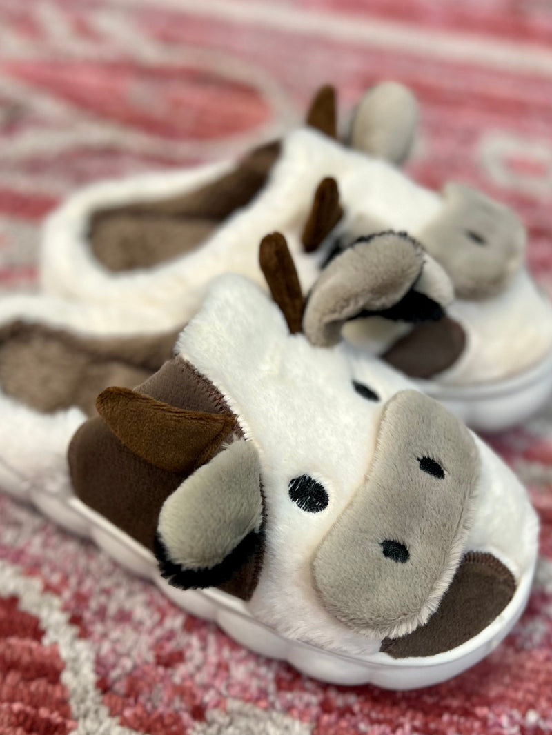 Mooove around with style and ease in these super soft and stylish cow-print Moooving Around the House Slippers. Whether you prefer black and white or brown and white, you'll look "udderly" adorable with horns! Cushiony plush fabric will keep your feet nice and comfy as you move around with a hard sole for support. Mooove it!