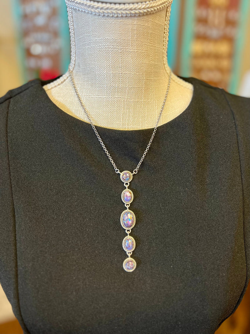 This exclusive Purple Rain Dangling Necklace is crafted with genuine sterling silver and set with genuine purple Mojave stones for a luxurious look. An 8" chain holds a 3" dangle pendant, adjustable with a 2" claw clasp creating the perfect fit. Elevate your style with this elegant and tasteful necklace.