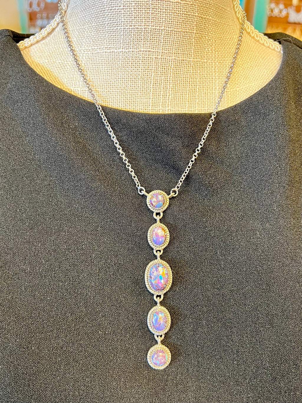 This exclusive Purple Rain Dangling Necklace is crafted with genuine sterling silver and set with genuine purple Mojave stones for a luxurious look. An 8" chain holds a 3" dangle pendant, adjustable with a 2" claw clasp creating the perfect fit. Elevate your style with this elegant and tasteful necklace.